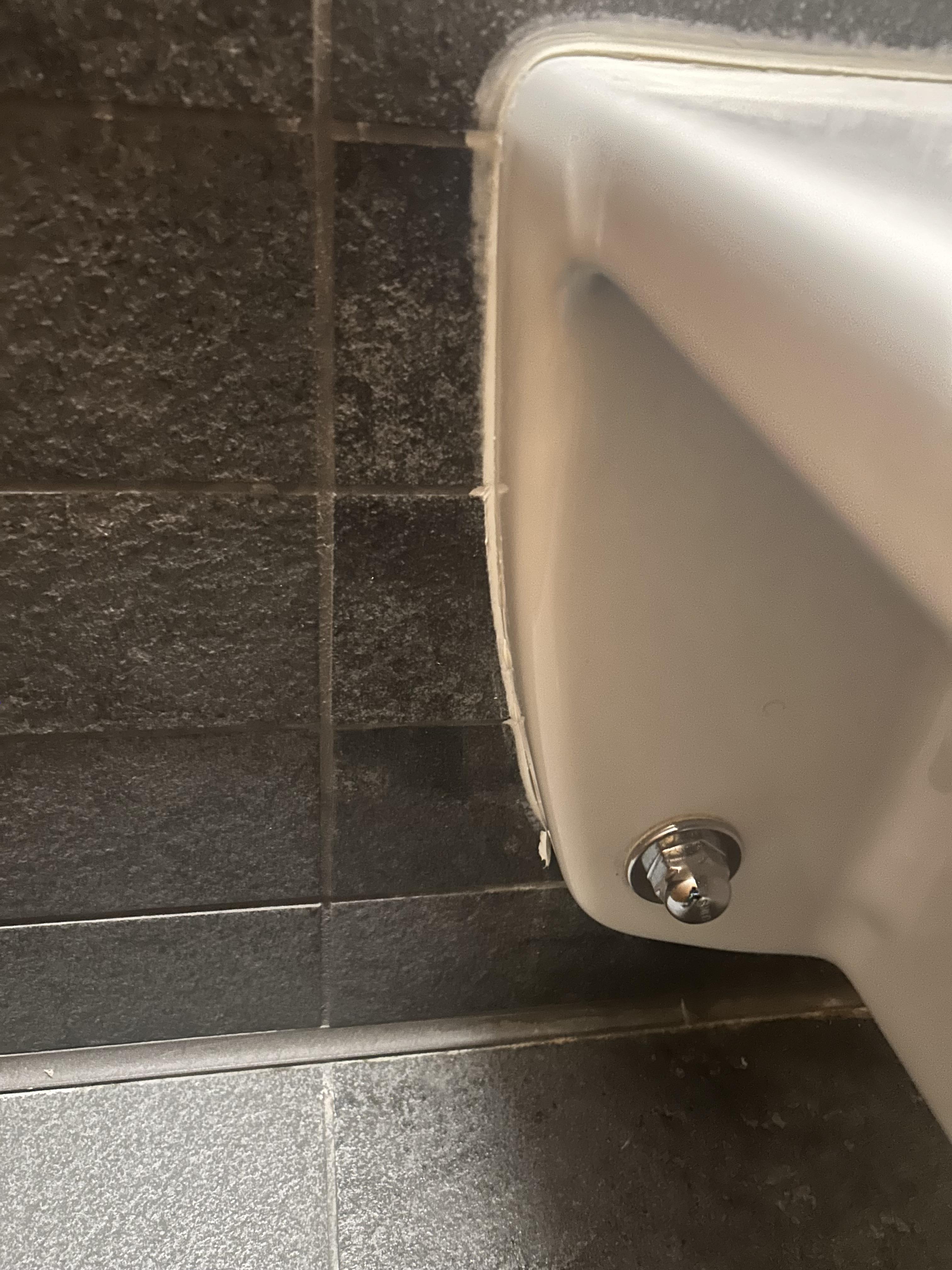 Area beneath a commercial restroom fixture after detail cleaning